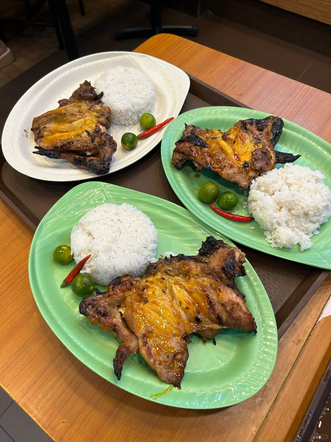 Boracay-Grilled chicken and rice at Mang Inasa restaurant in the Philippines, topped with lime