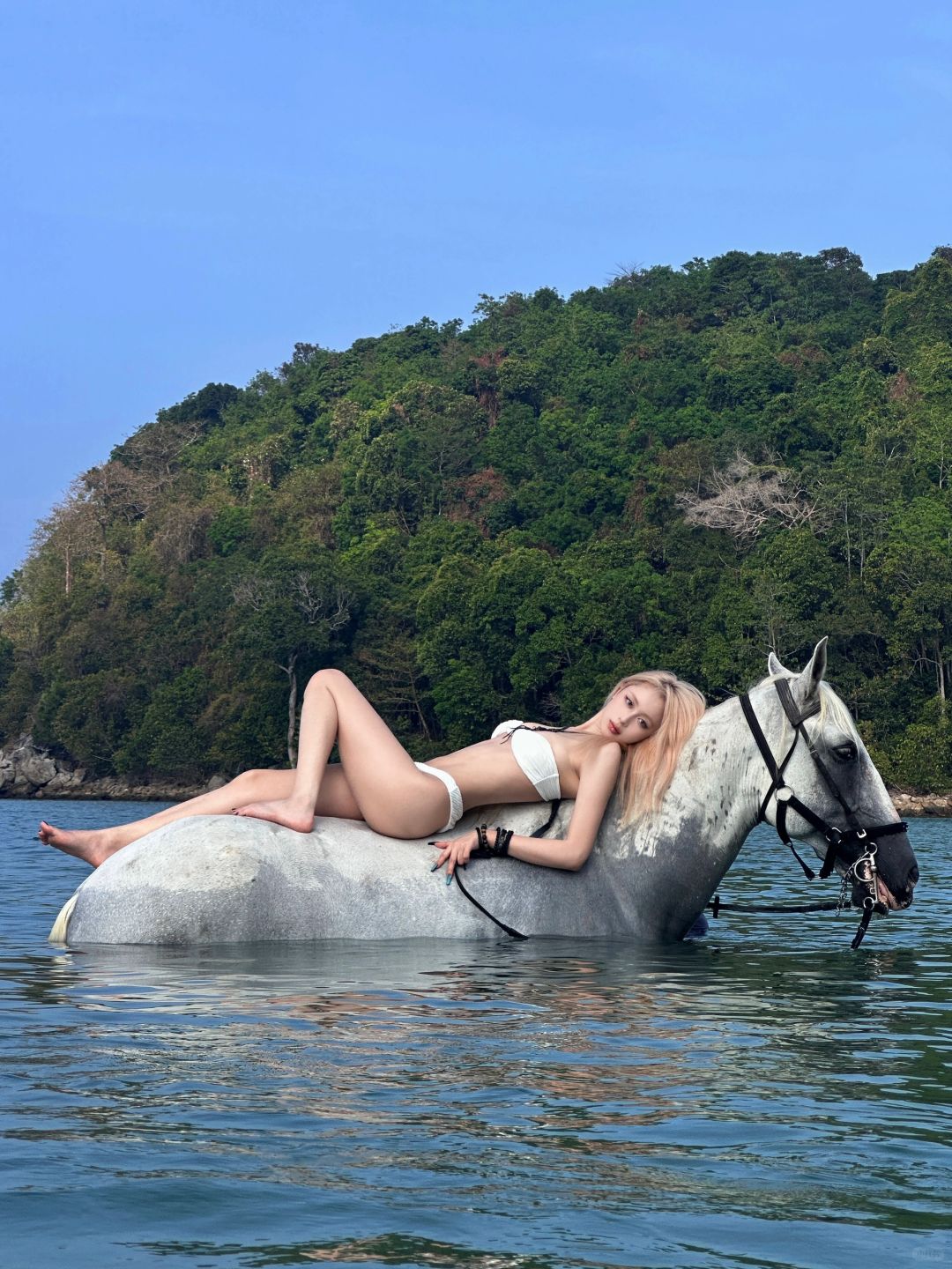 Phuket-Beautiful girl traveling on horseback riding on the beach in Phuket with clear sea and sky