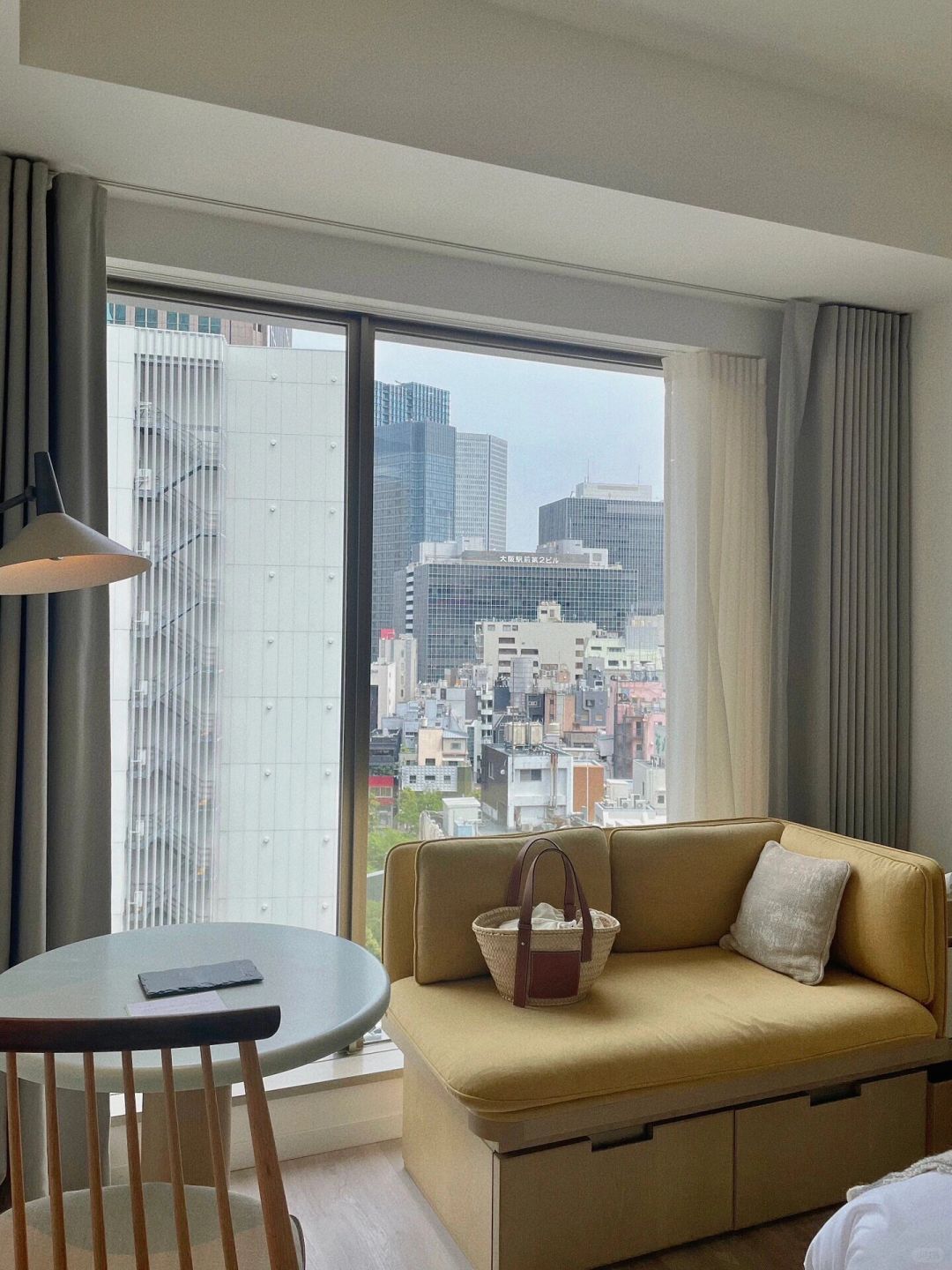 Osaka-Zentis Hotel in Osaka, Japan, with a log-style decoration and a terrace surrounded by green plants