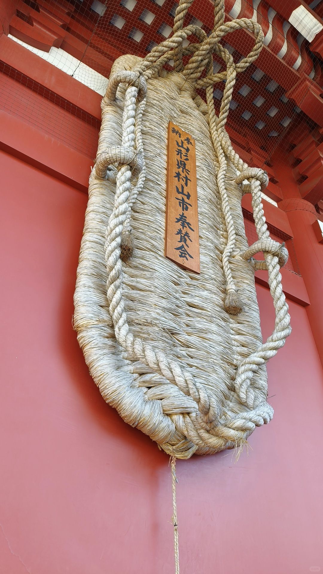 Tokyo-Sensoji Temple crowded with people has red beams and black tiles next toAsakusa Shrine