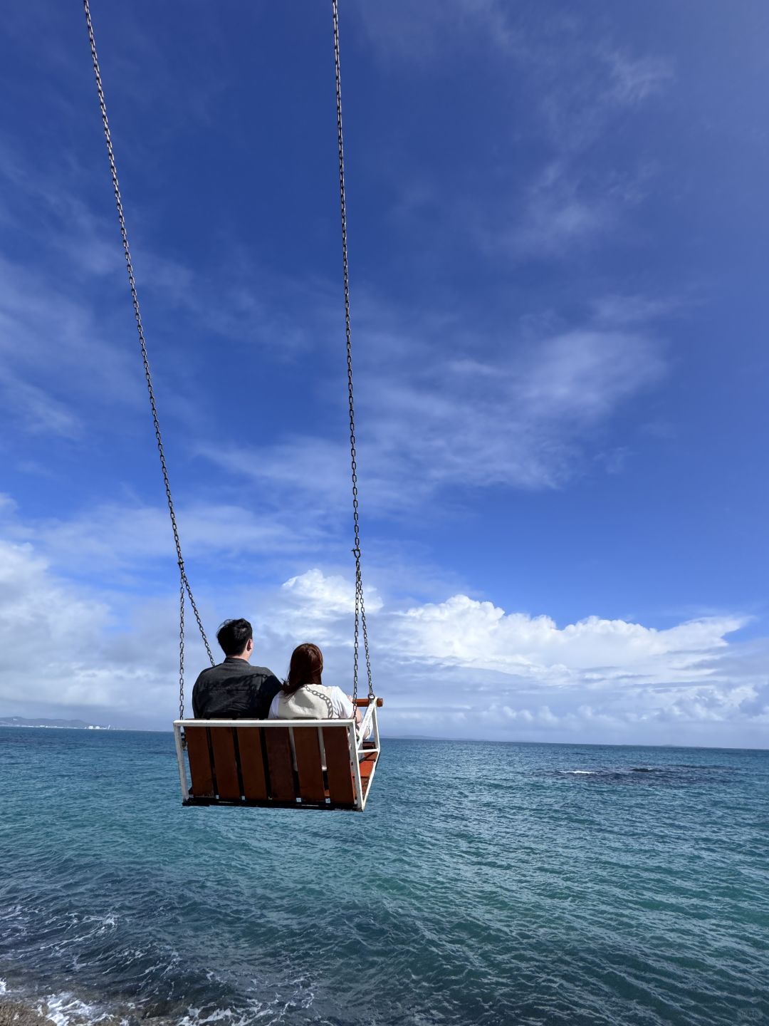 Okinawa-Cape Chinen Park and  Heart Bell record videos and take photos on swings