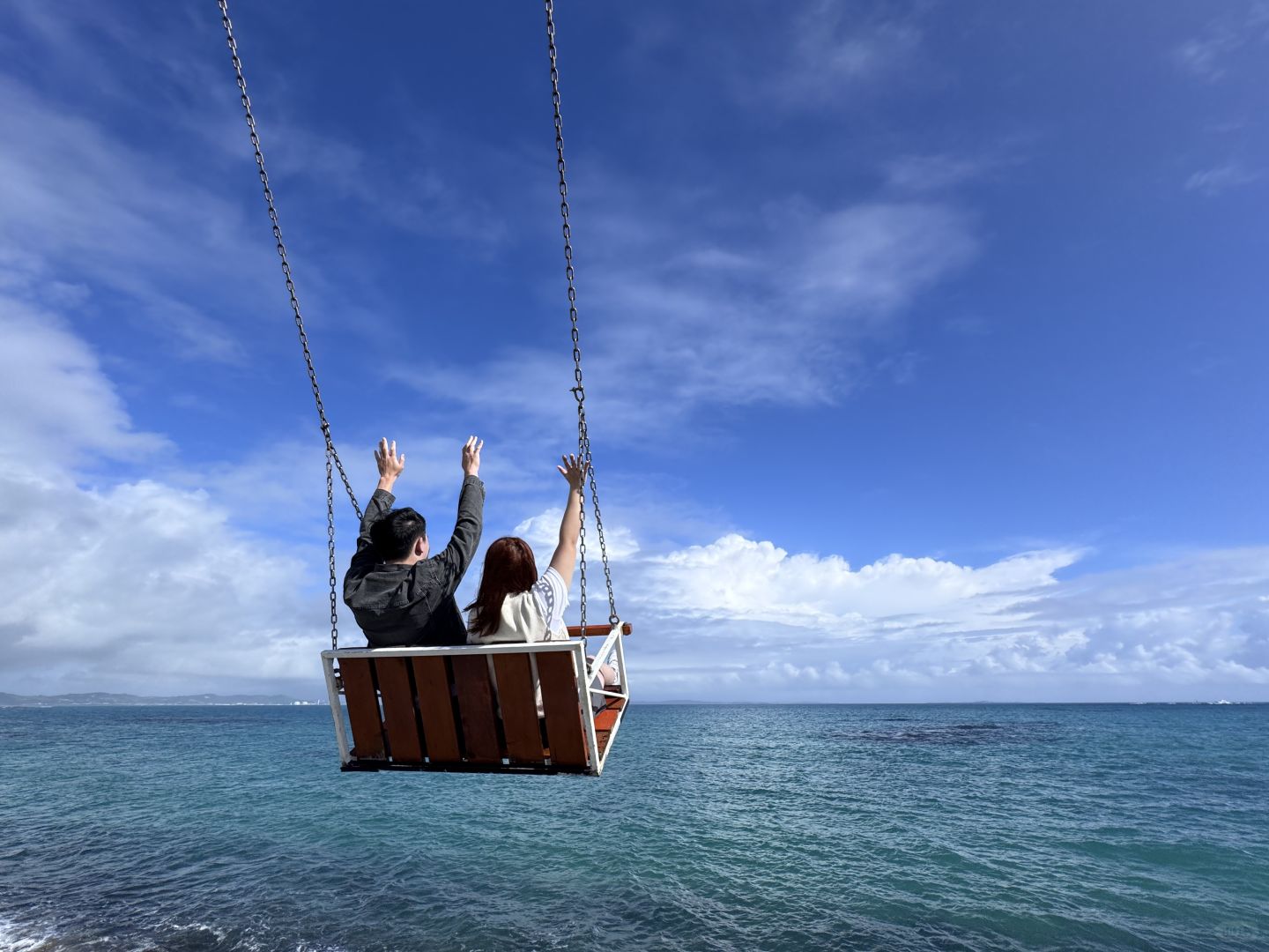 Okinawa-Cape Chinen Park and  Heart Bell record videos and take photos on swings