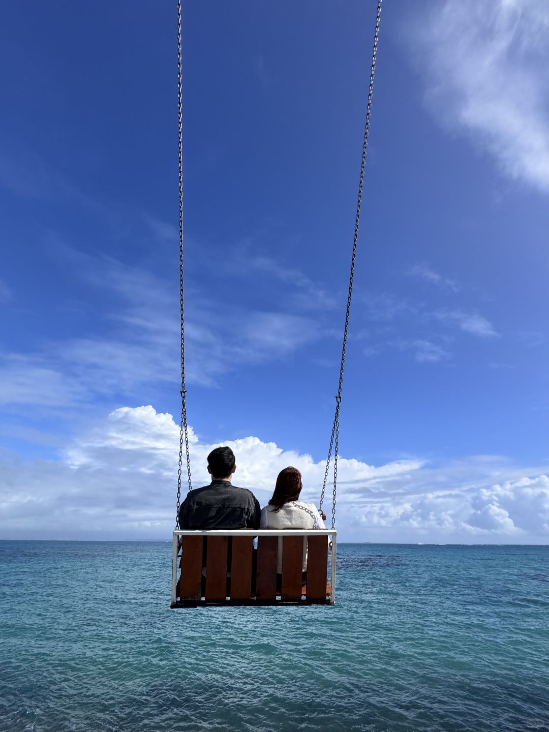 Okinawa-Cape Chinen Park and  Heart Bell record videos and take photos on swings