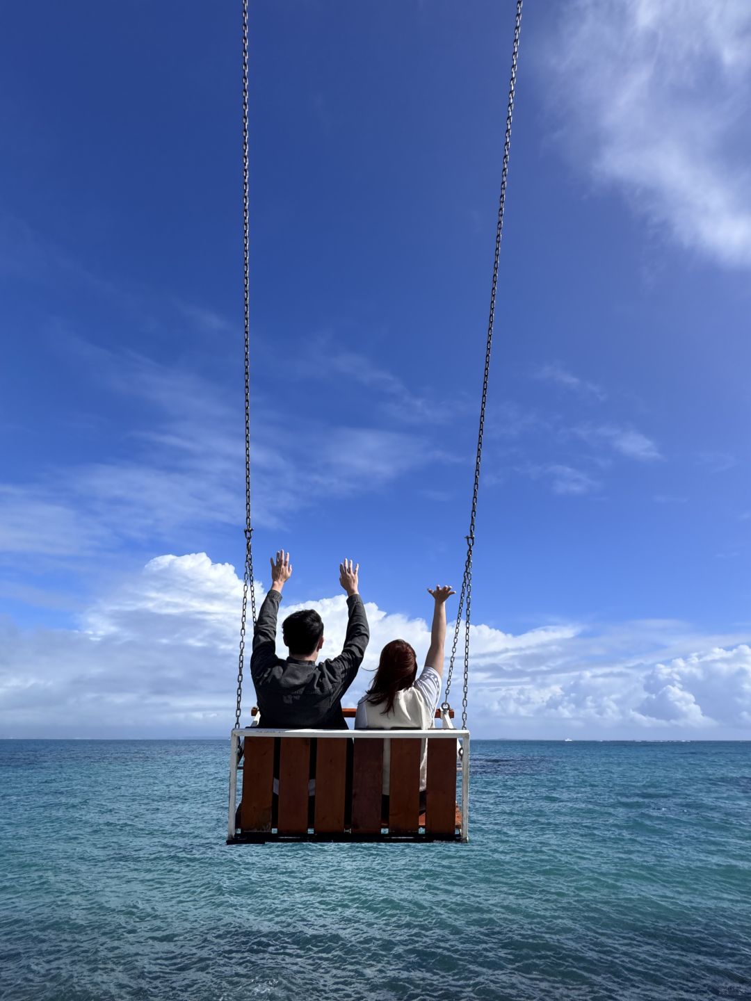Okinawa-Cape Chinen Park and  Heart Bell record videos and take photos on swings