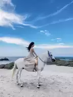 Girls riding horses on Hua Hin Beach, must choose tall white